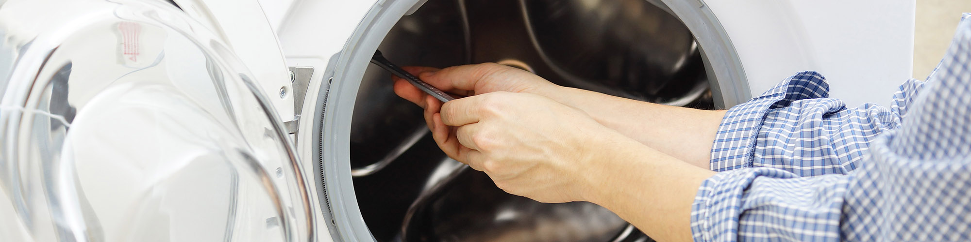 Technician Repairing a Washing Machine